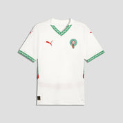 White sports jersey with green and red accents on a light gray background