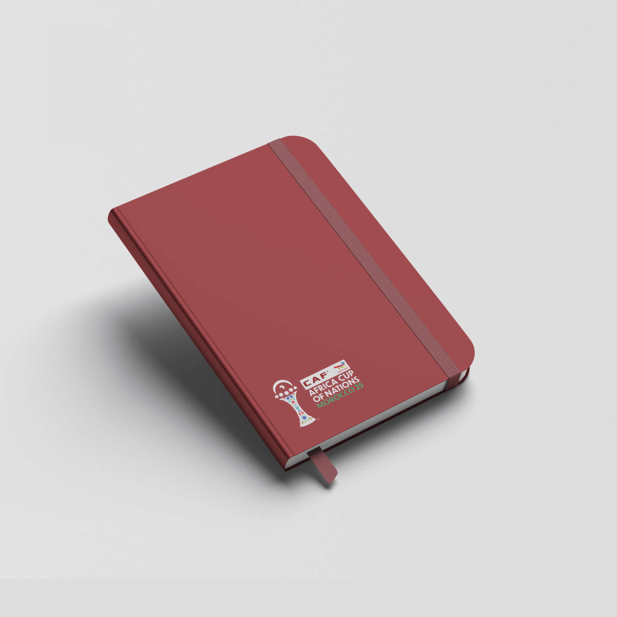 Red notebook with a logo on a light gray background